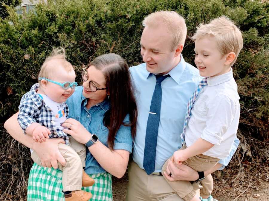 Family of four take photos together while dressed up for church