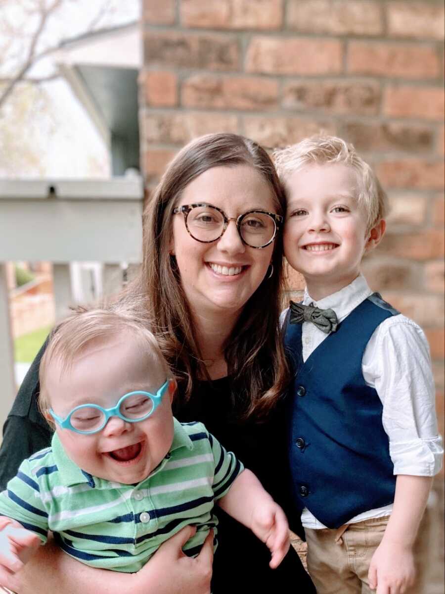 Mom takes a photo with her two sons all dressed up in church attire