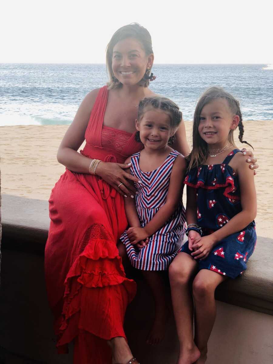 mom with her two daughters on the beach