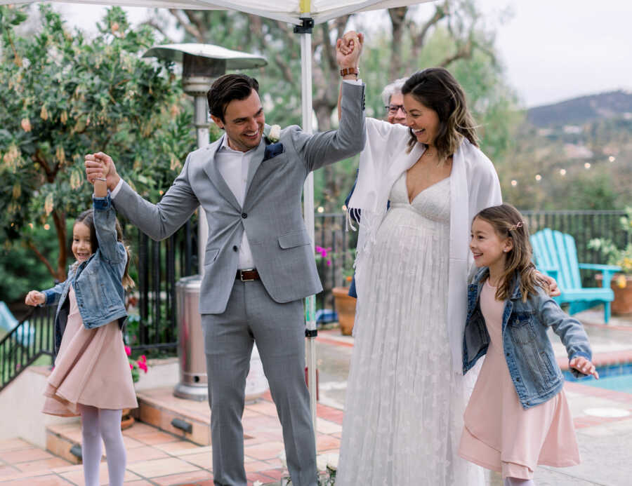 couple on their wedding day and two kids