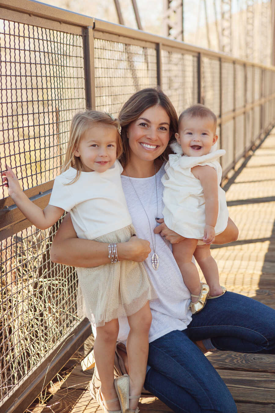 mom and her two daughters smiling