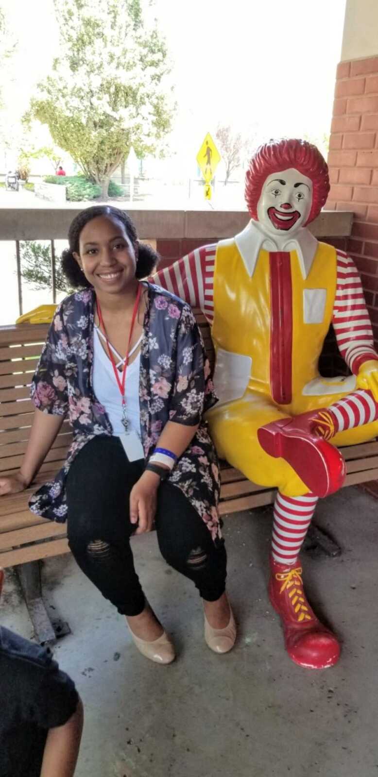 Mom of son fighting cancer takes a picture with a Ronald McDonald statue