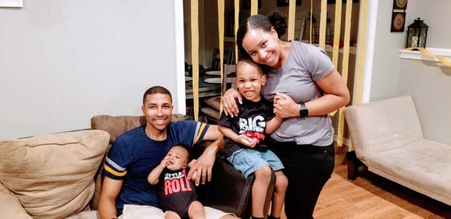 Family of four take a photo with their newborn son