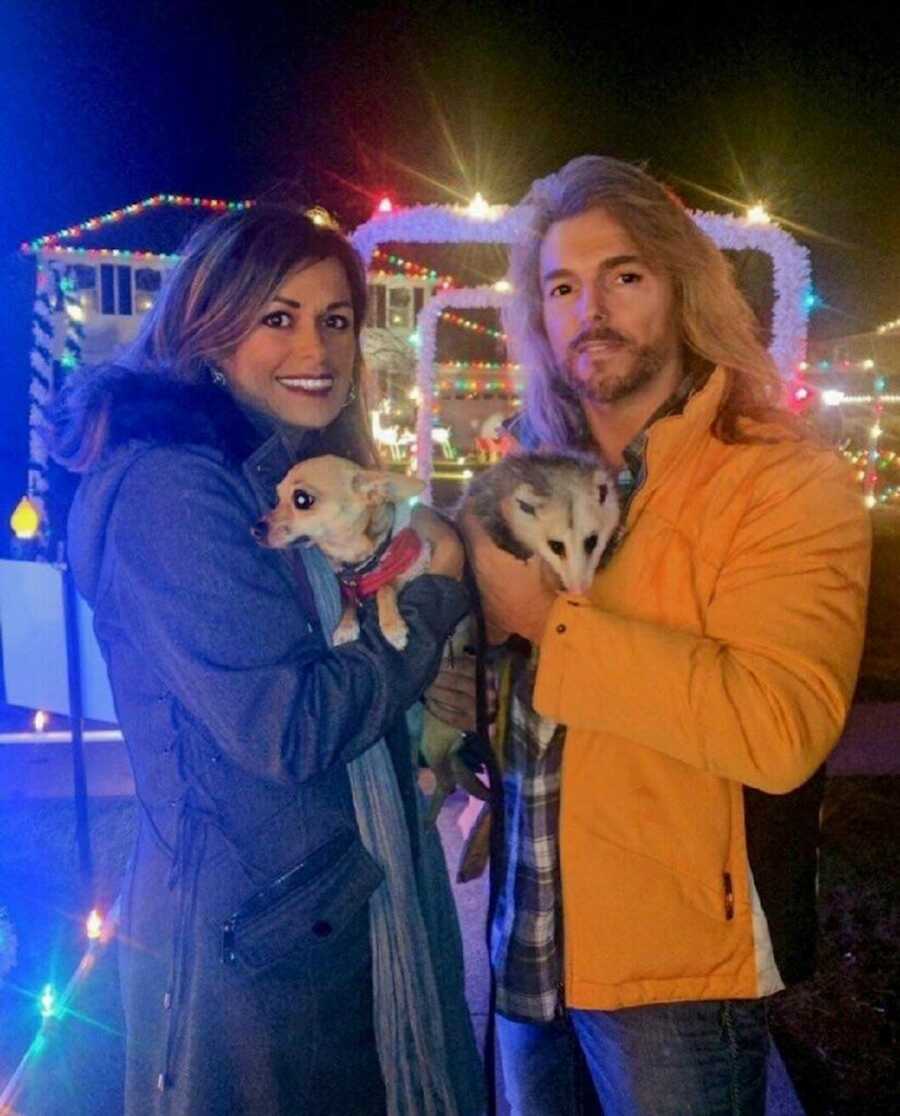 couple with their dog and possum