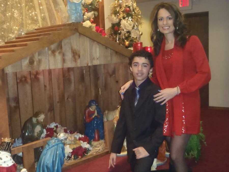 mom and her son on christmas at a nativity scene
