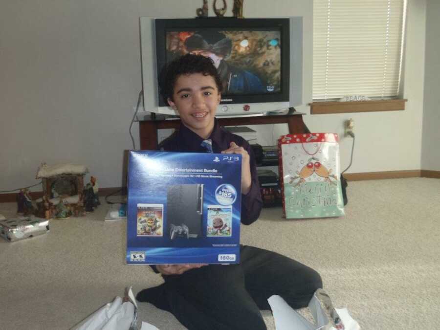 young boy holding a toy on Christmas