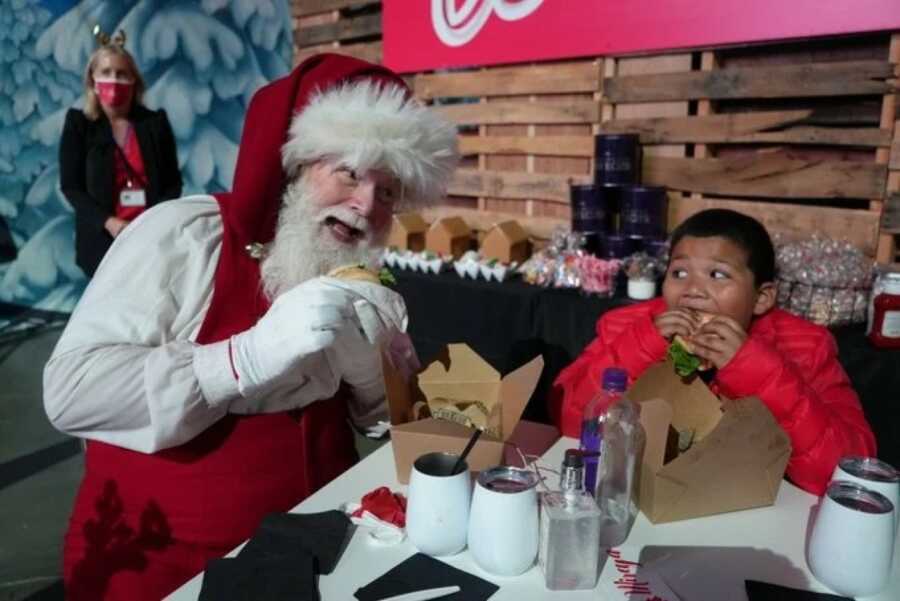 little boy with Santa eating lunch together