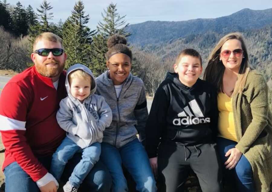 family with the girl they adopted on a hike