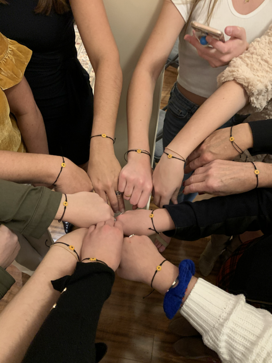 family wearing sunflower wrist bands to honor their aunt