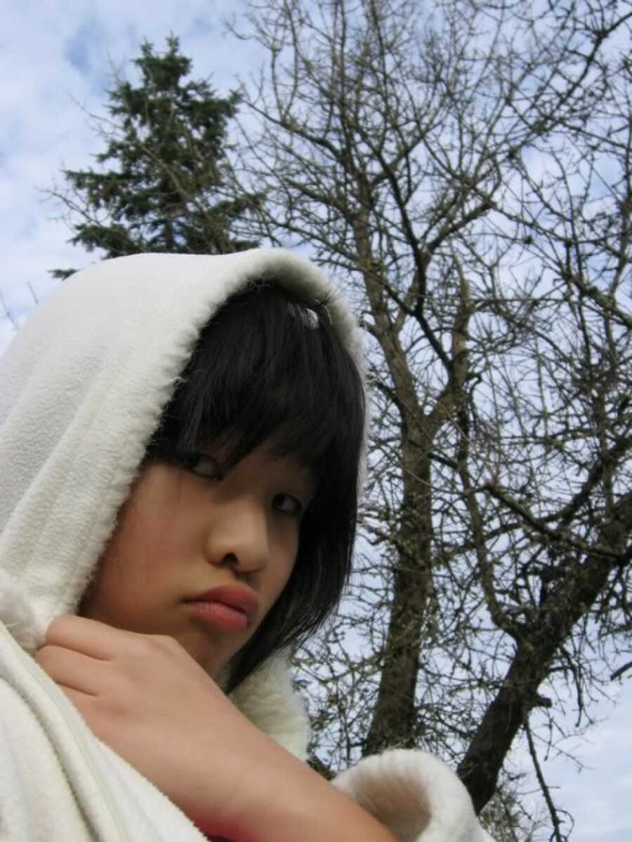 teenage girl posing in her sweatshirt