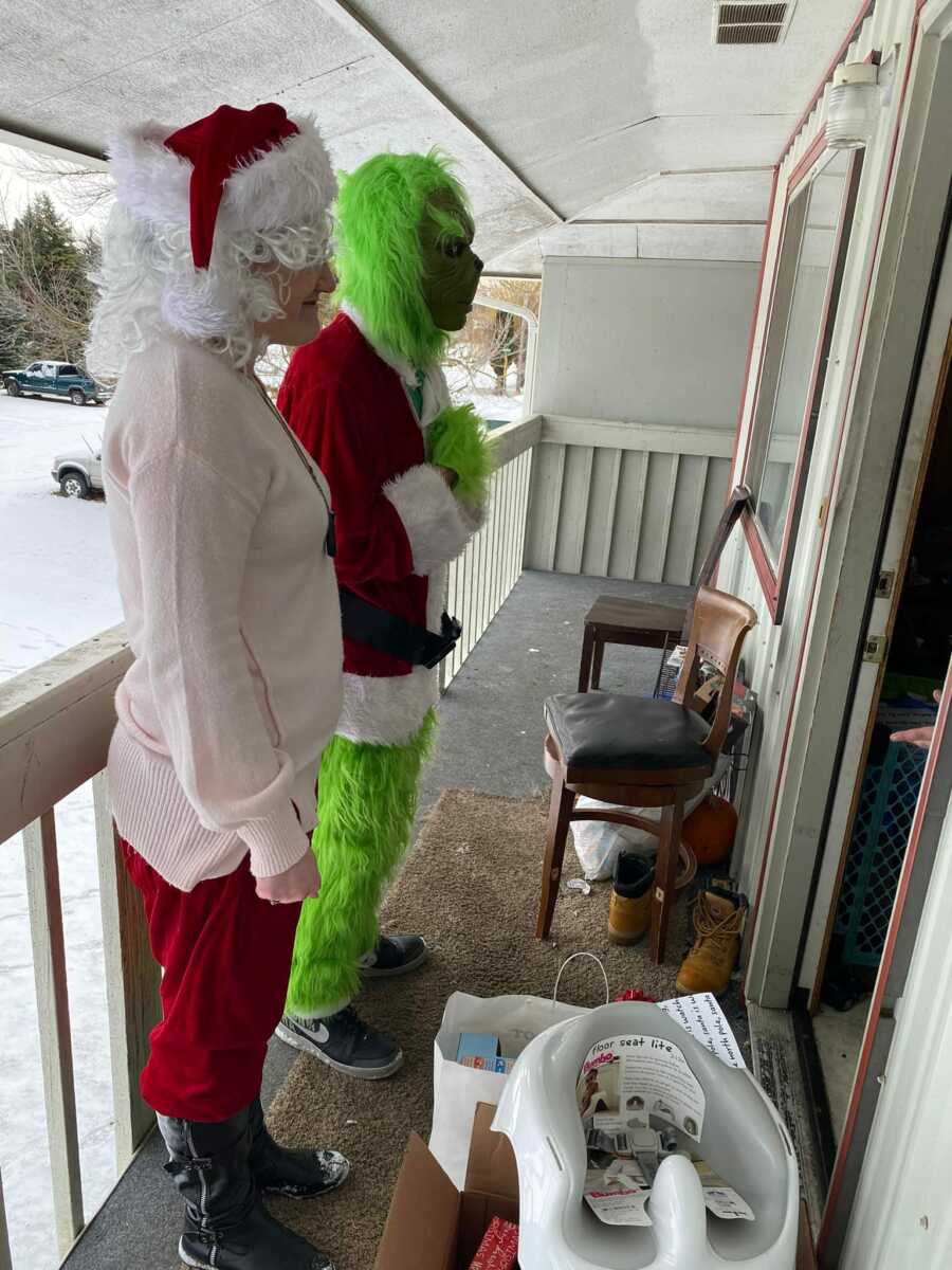 grinch and santa on someone's front porch