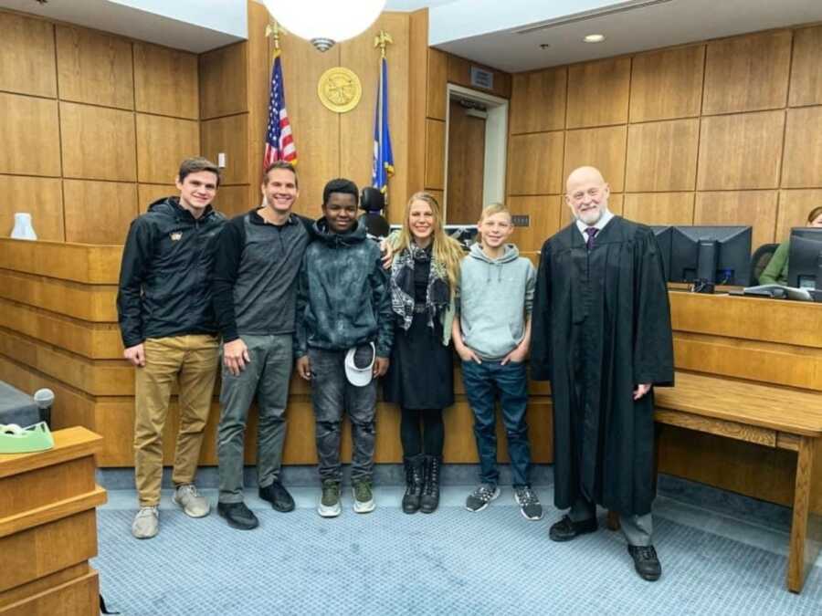 mom smiling with her sons after she officially adopted them