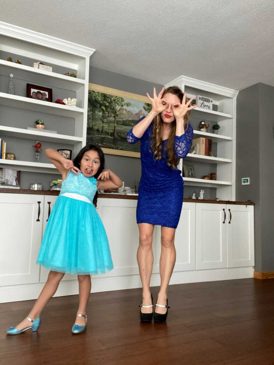 mom and daughter in a dress making a funny face