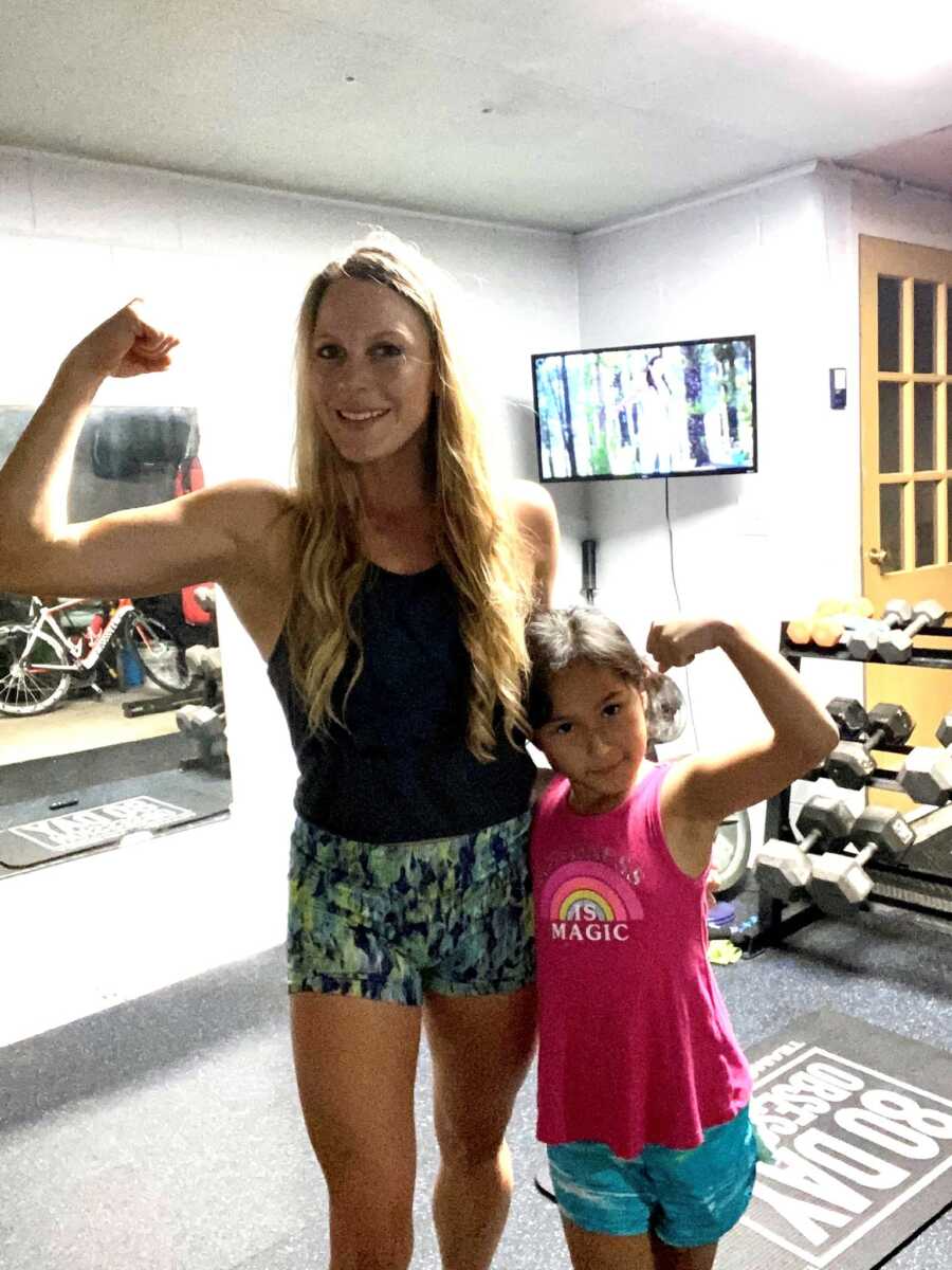 mom and daughter showing off their muscles again