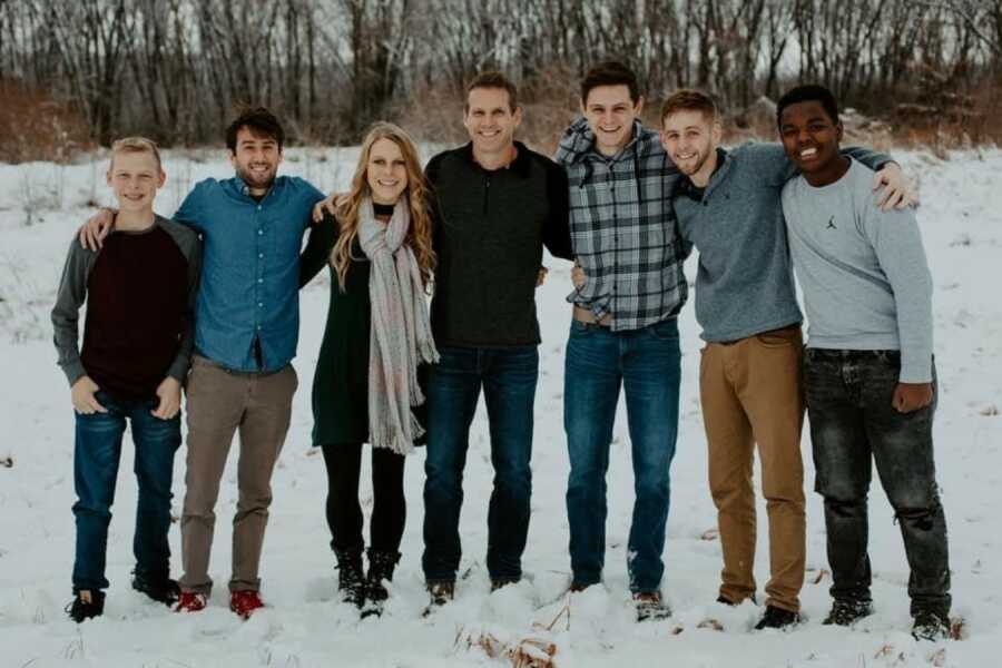 family posing in the snow for a family photo