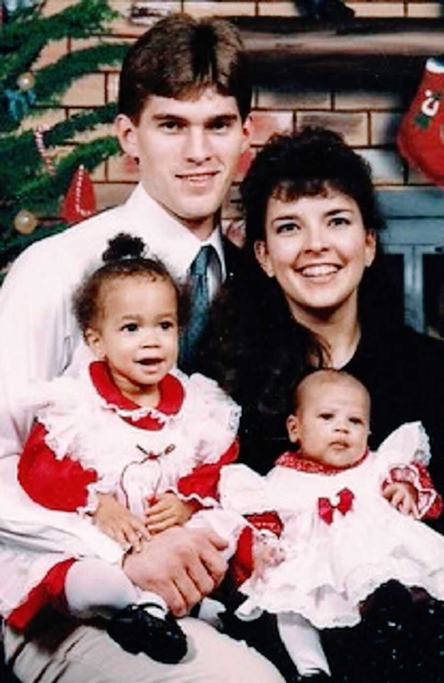 Parents with their biracial adopted children
