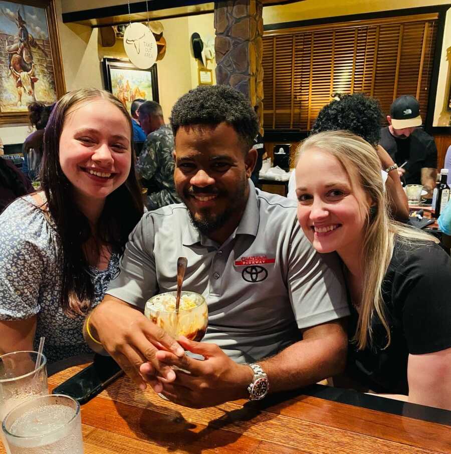 man with his adoptive family at a restaurant