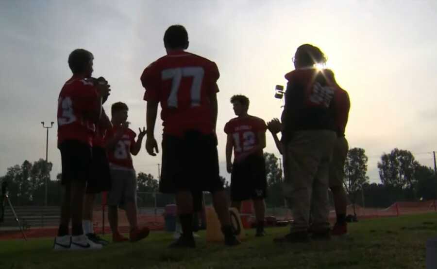 team huddled together during practice 