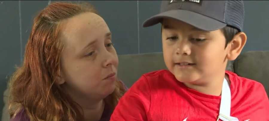 mom with little boy who was rescued by his older brother