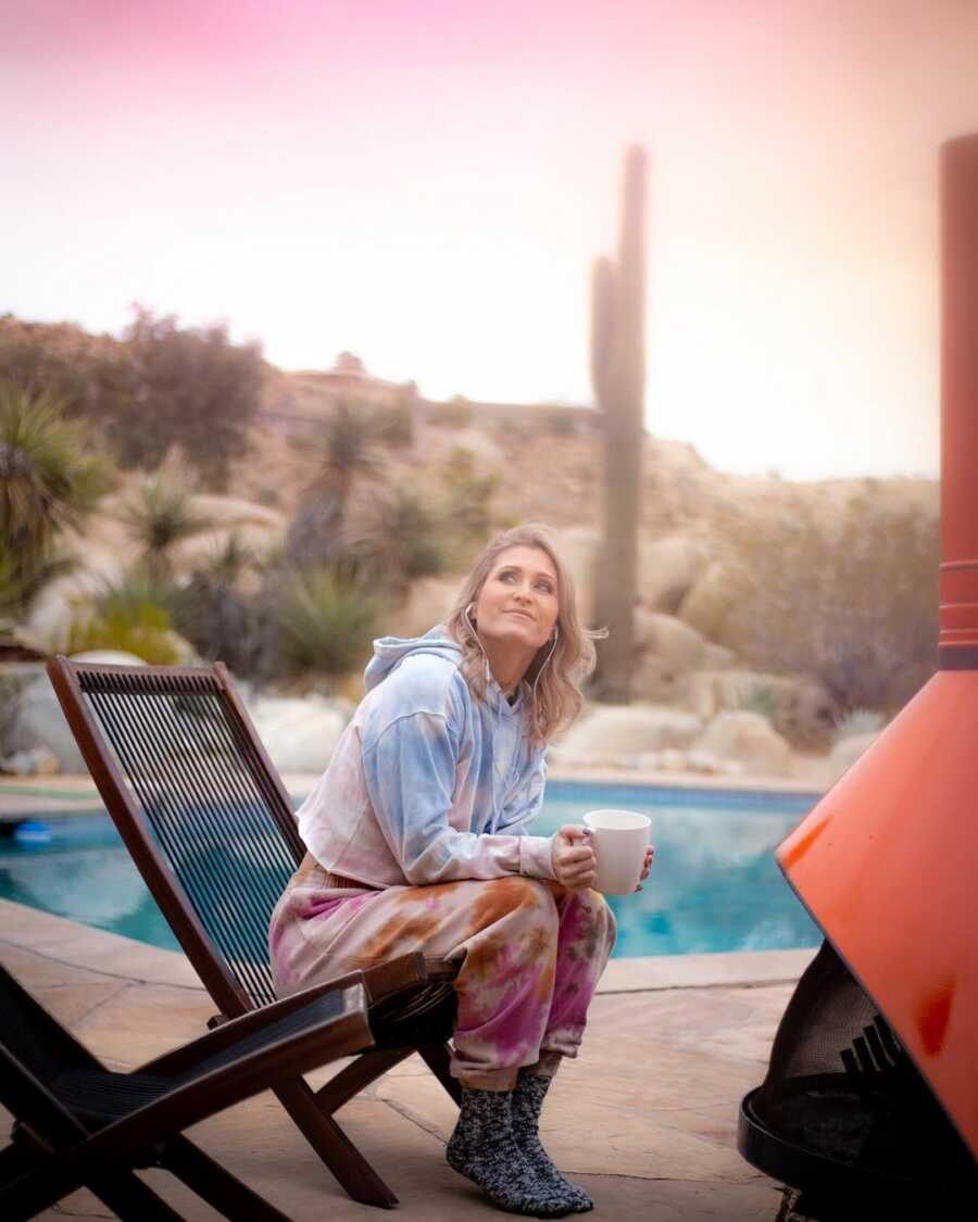 woman sitting in her chair drinking her coffee reflecting