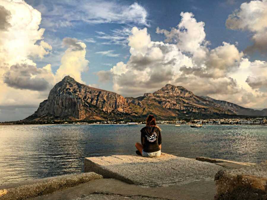 woman sitting in front of the mountains