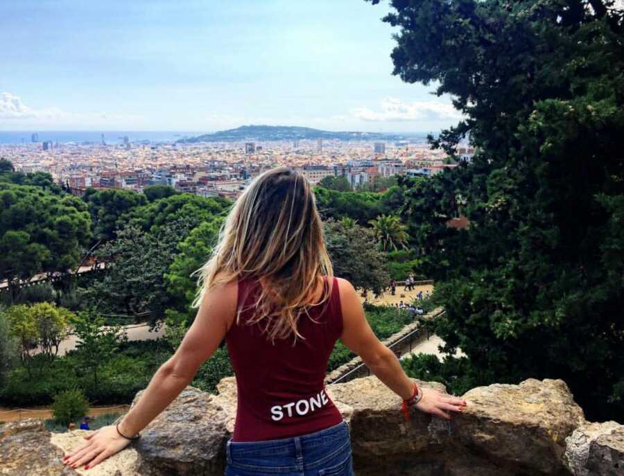 woman looking out at the view on a hike in europe