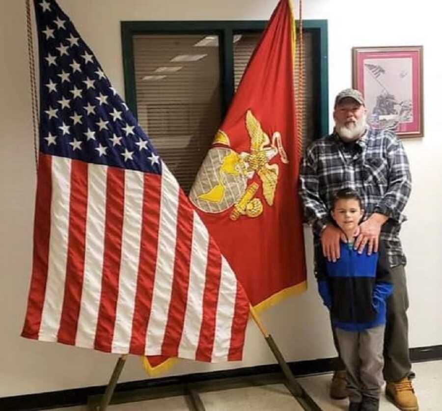 Jayden and his dad take a picture at the Marine Corps. 