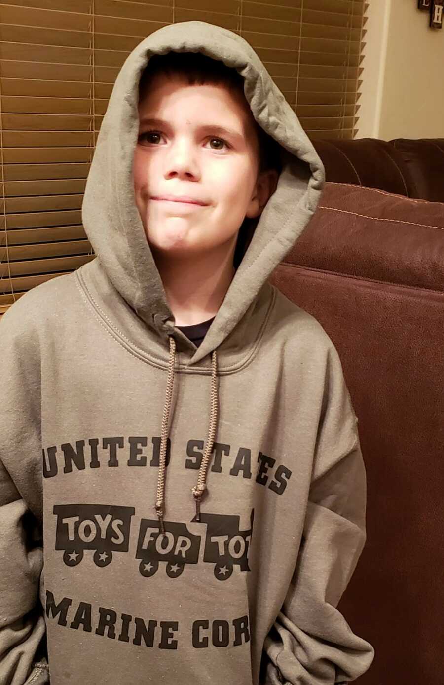 Jayden become a Toys For Tots Junior Ambassador and wears a special Toys For Tots hoodie.