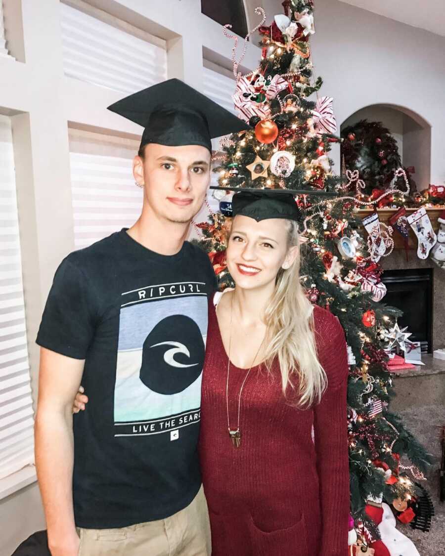 New parents pose for graduation picture after chaotic semester of school.