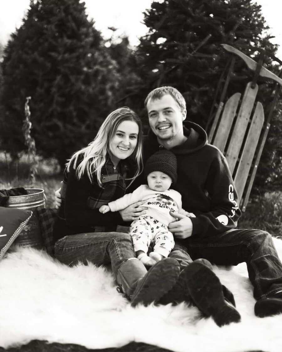 Husband and wife take family pictures with their baby boy. 