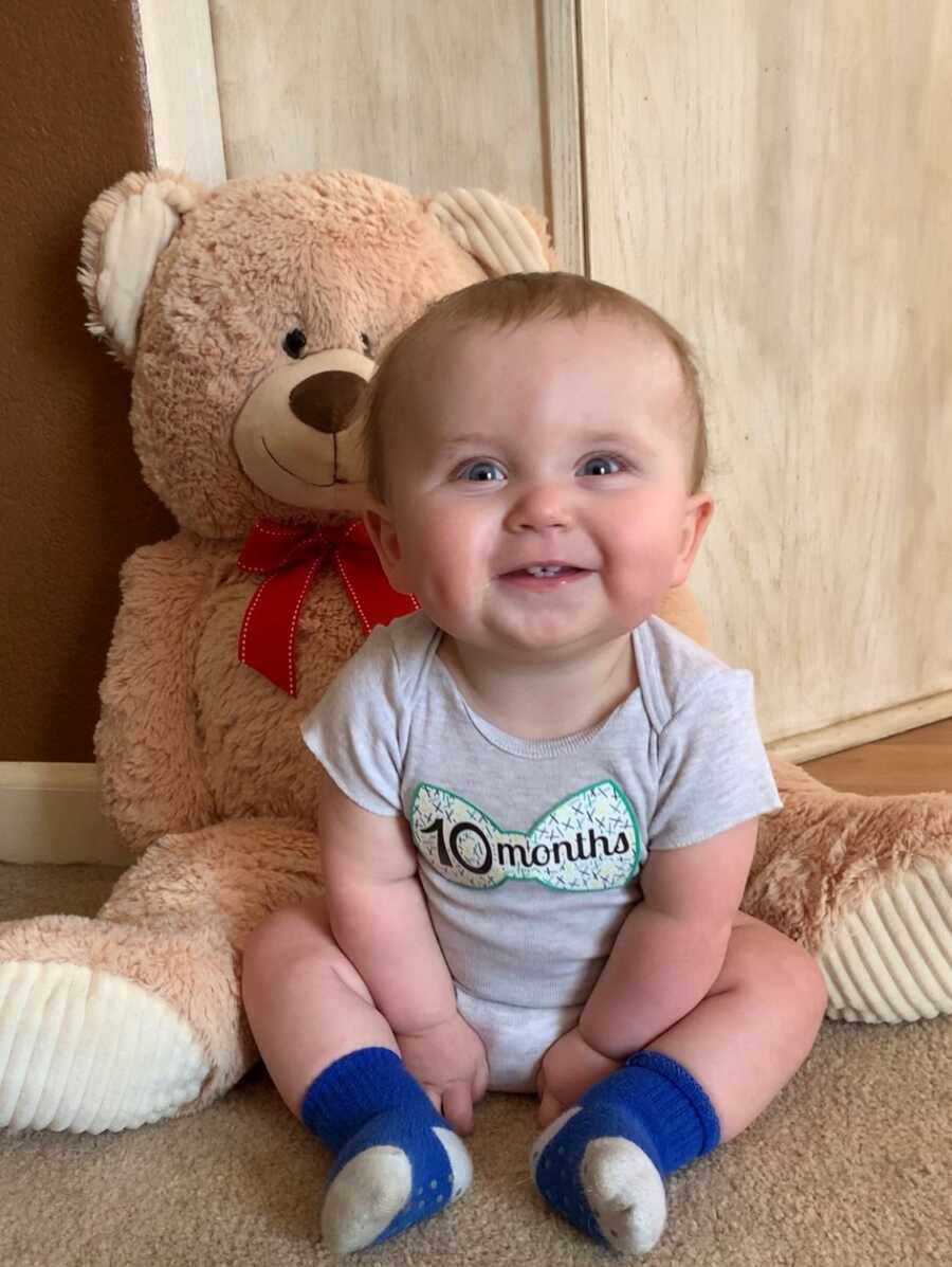 son with teddy bear smiling