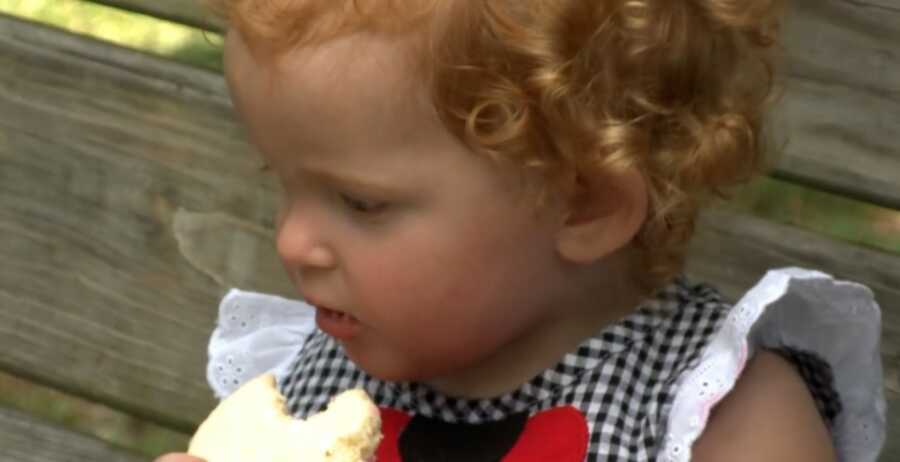 baby eating food after being rescued