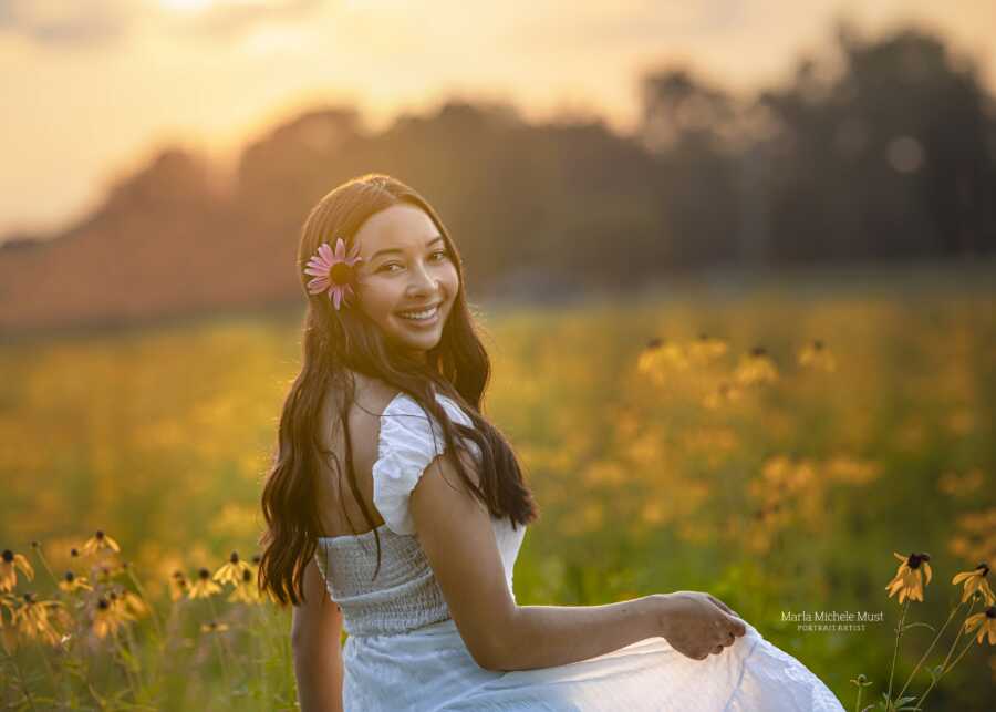 girl shot in oxford shooting smiling and in the flowers at golden hour