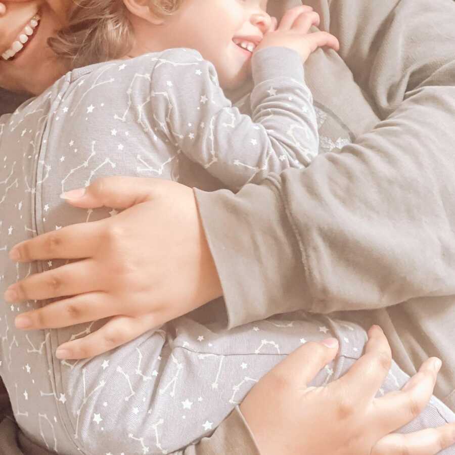 Foster mom hugs her child. 