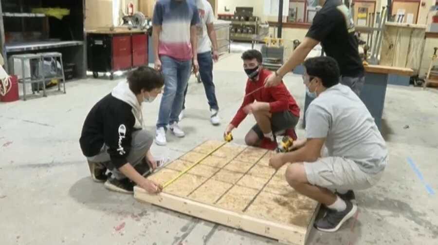 robotics team building a shelter for the wheelchair bound boy