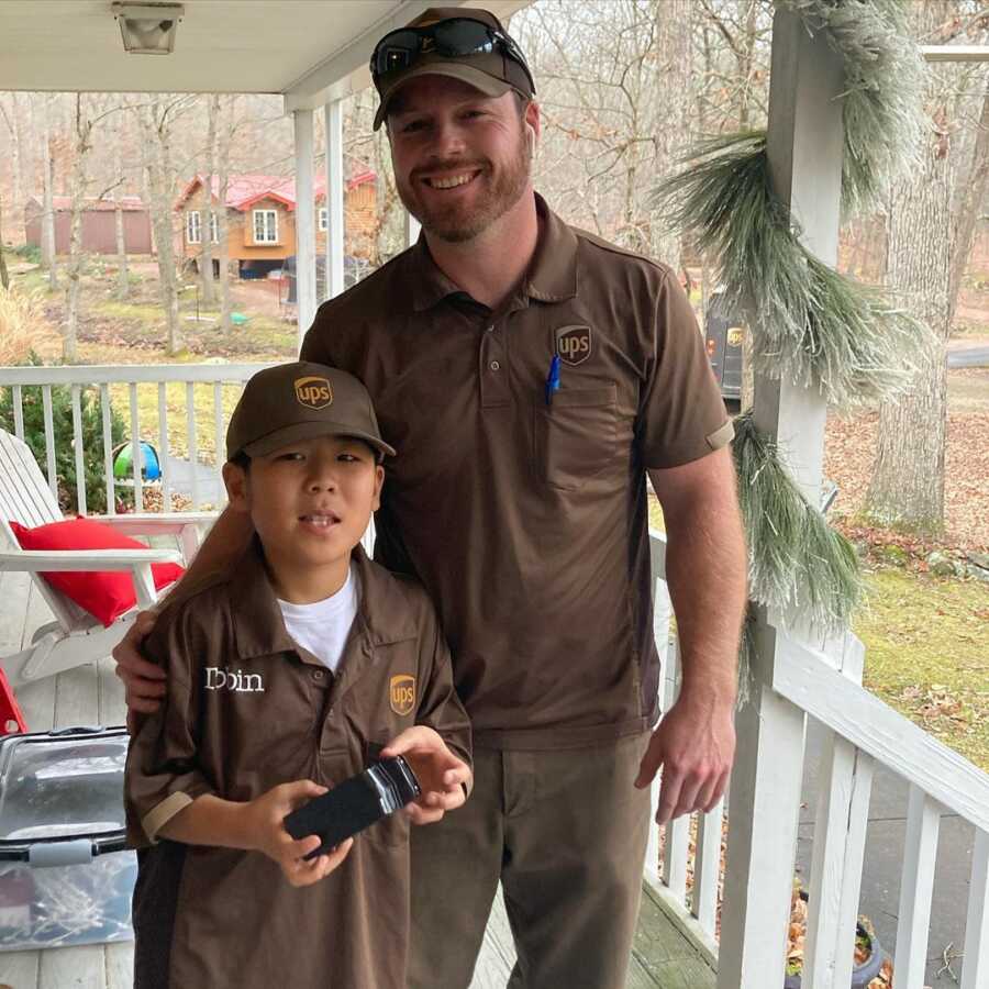 little boy in his uniform with his local ups driver