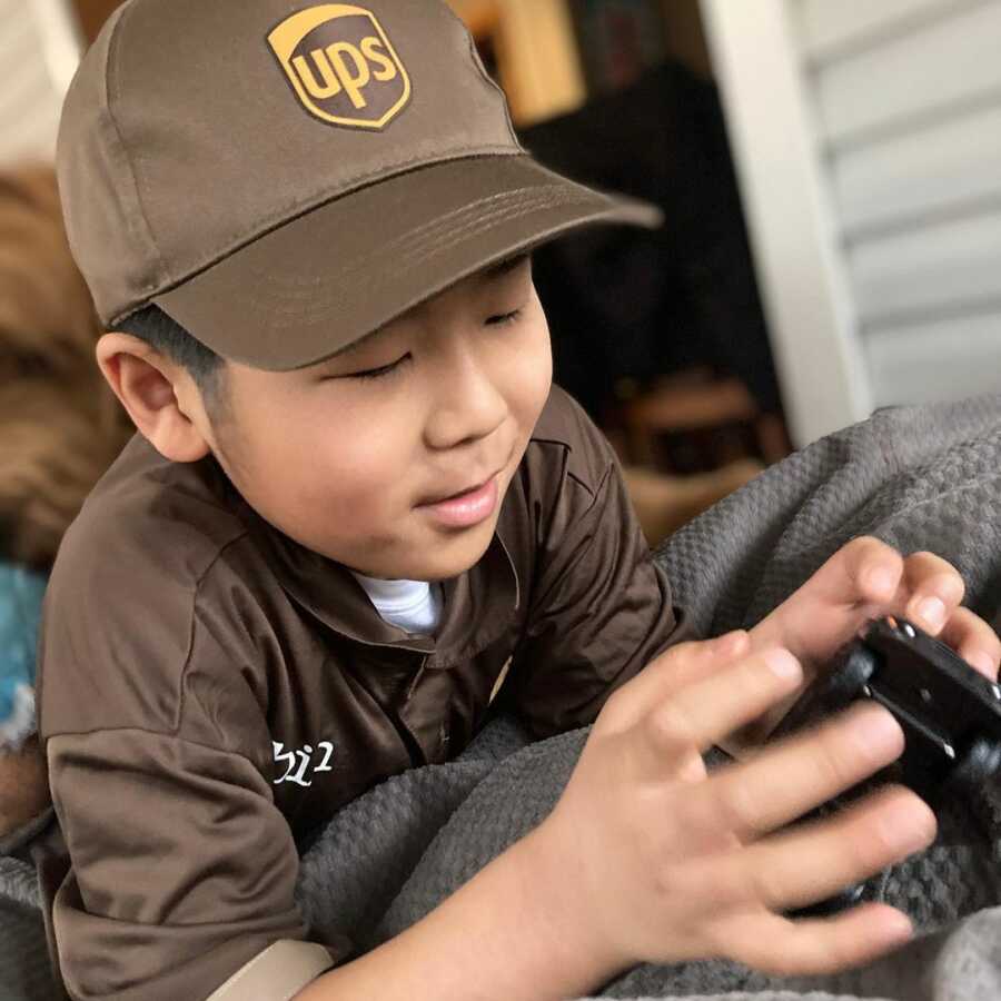 little boy playing with his new UPS truck toy