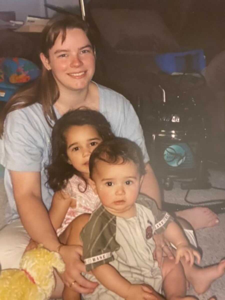 mom with her son and her daughter on the ground smiling