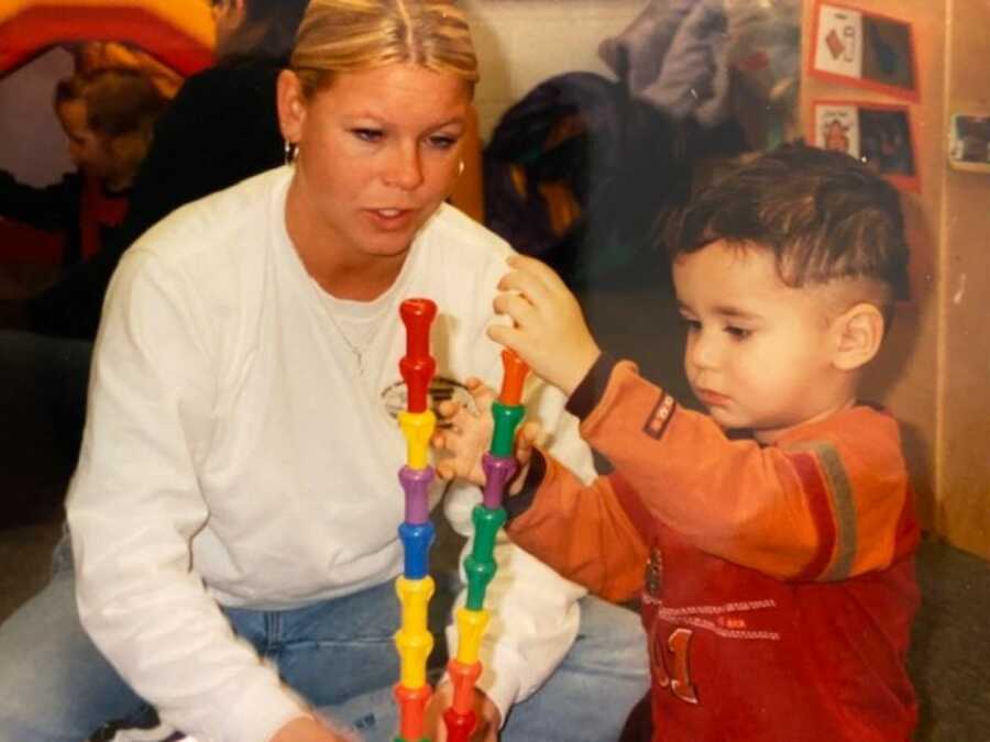 teacher with little boy who struggled in school building