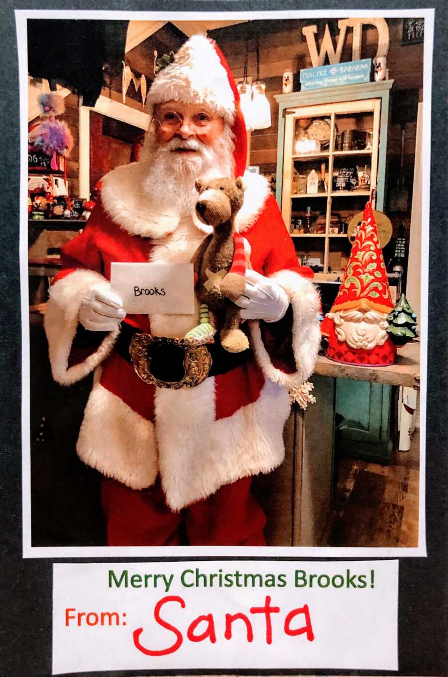 Santa holding a letter for a body named Brooks and a teddy bear as a Christmas gift 