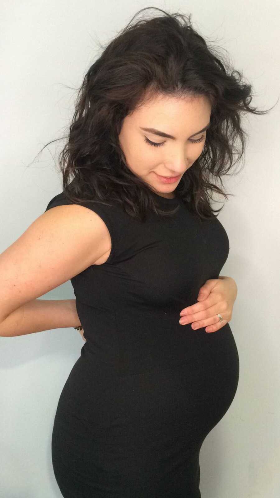 pregnant mom holding her bump
