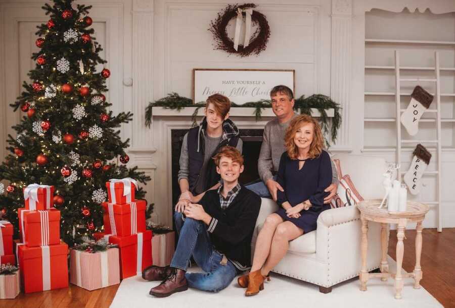 family portrait next to Christmas tree