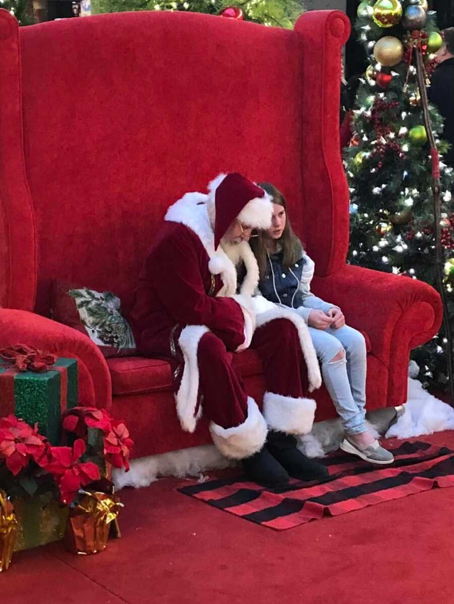 santa with a little girl who is upset her friend moved