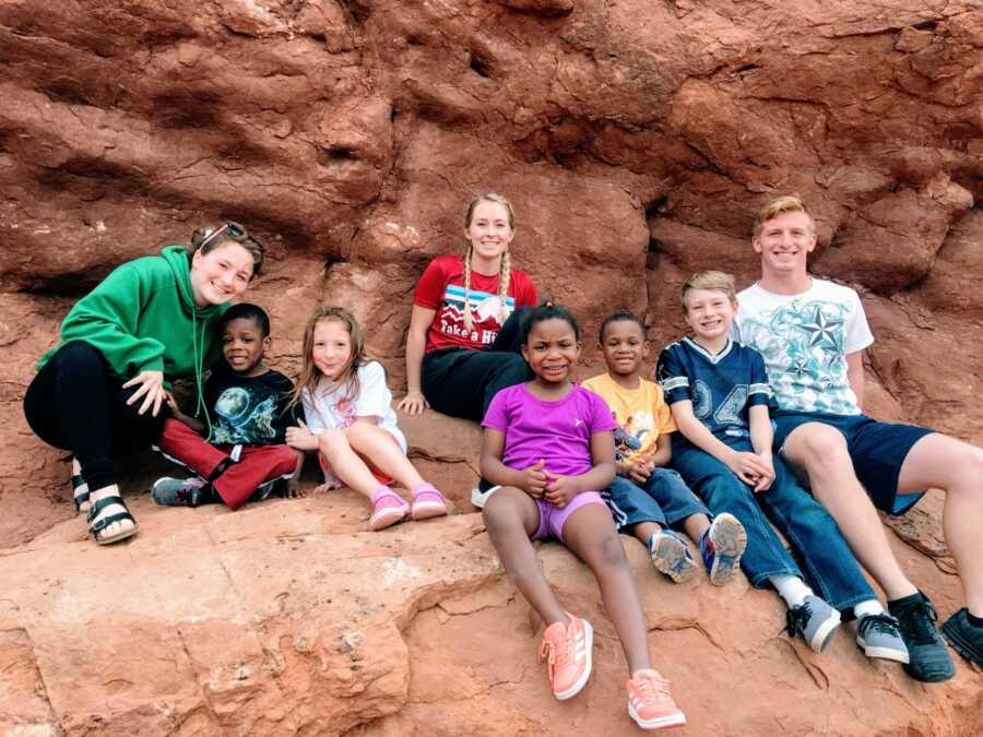 Mom takes a photo of her eight children rock climbing together while on an outdoor adventure vacation