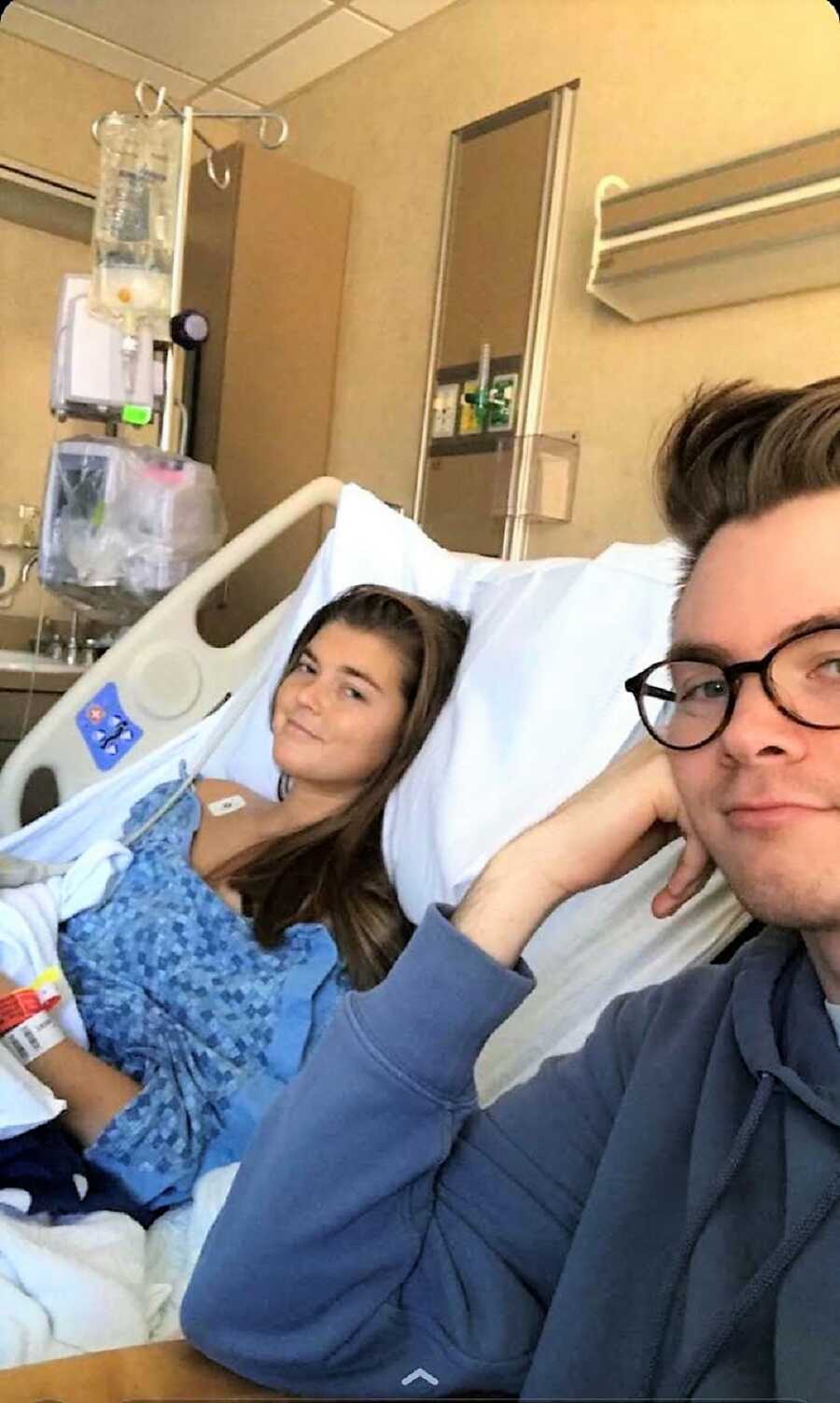 Woman battling chronic pain takes a selfie with her friend at the hospital