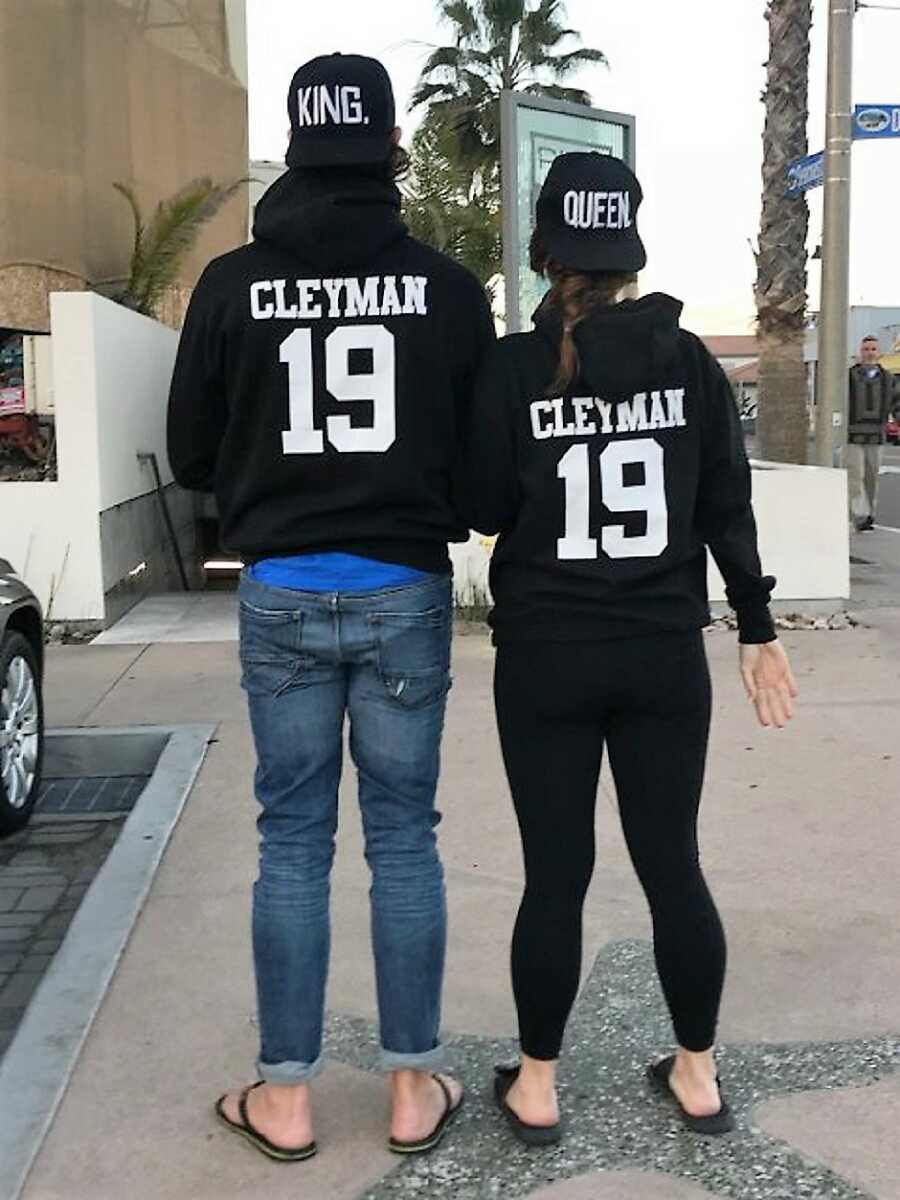 husband and wife wearing matching jackets with their names 