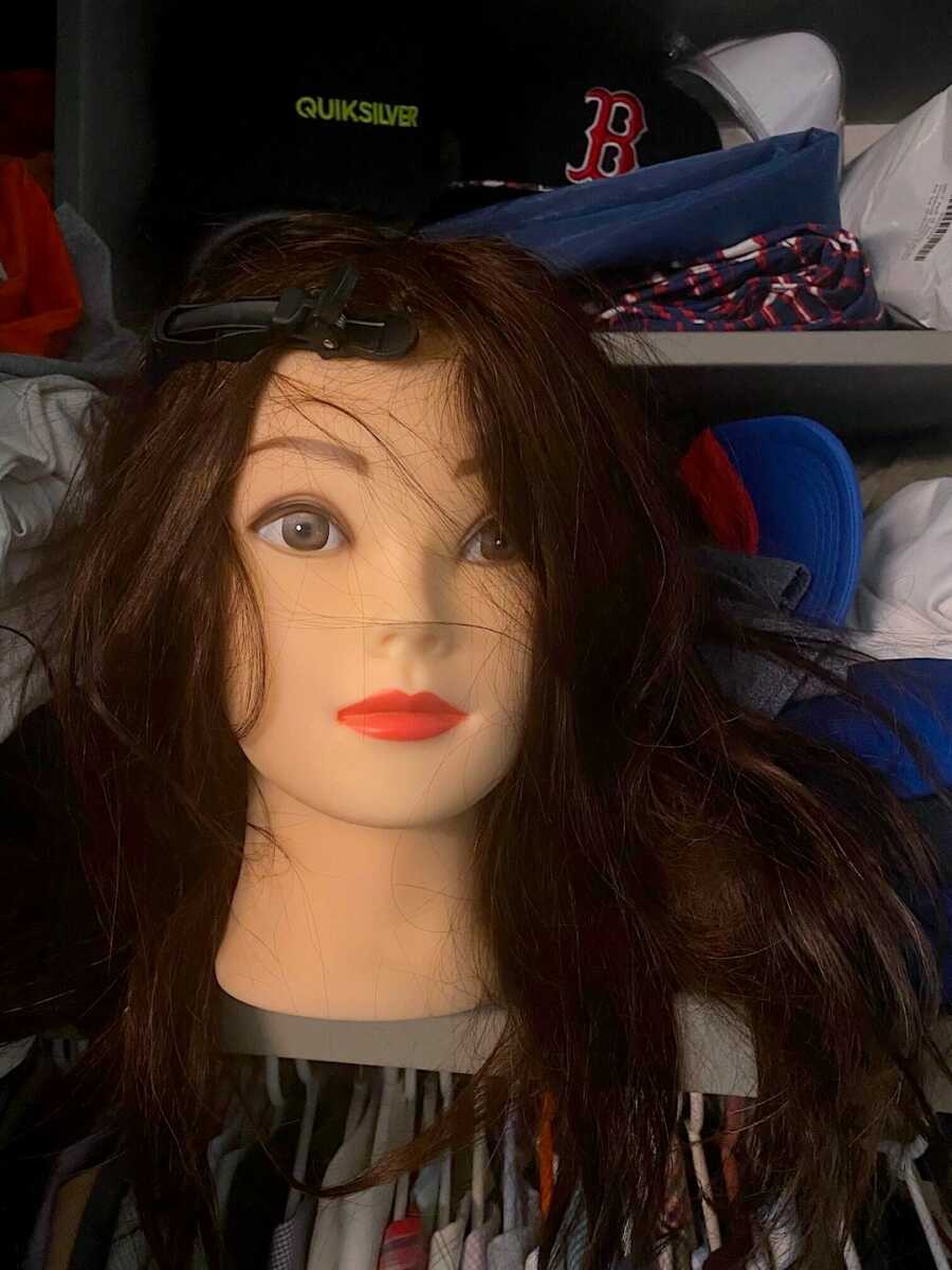 mannequin head with long hair that single dad used to practice hair styles
