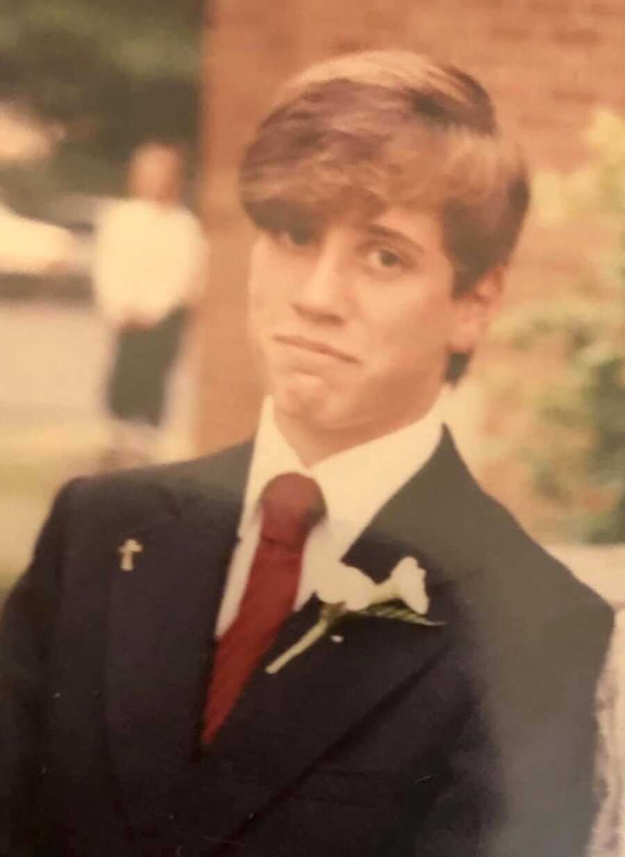 single dad when he was young wearing a suit with long floppy hair