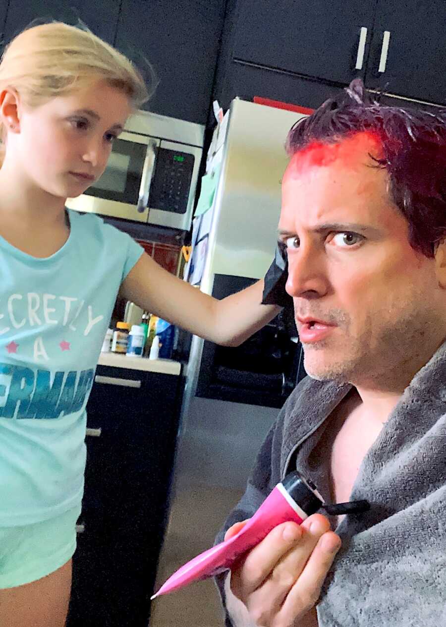 single father has his daughter dye his hair a bright pink color, he has dye all over his hair and forehead