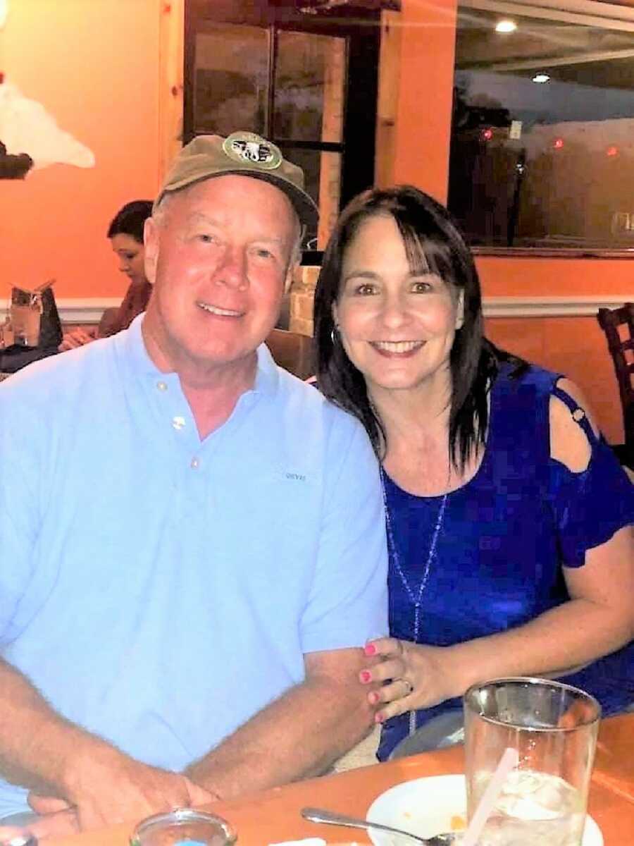 happy Husband and wife have dinner at a restaurant wearing blue shirts